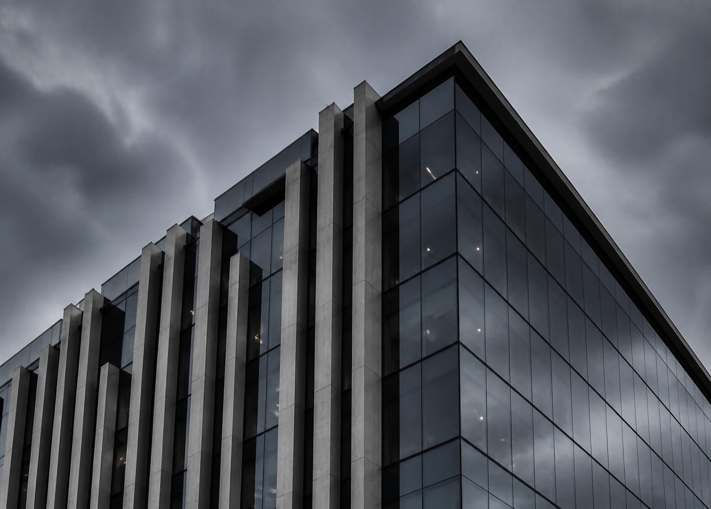 Modern commercial office building with dark glass and concrete facade